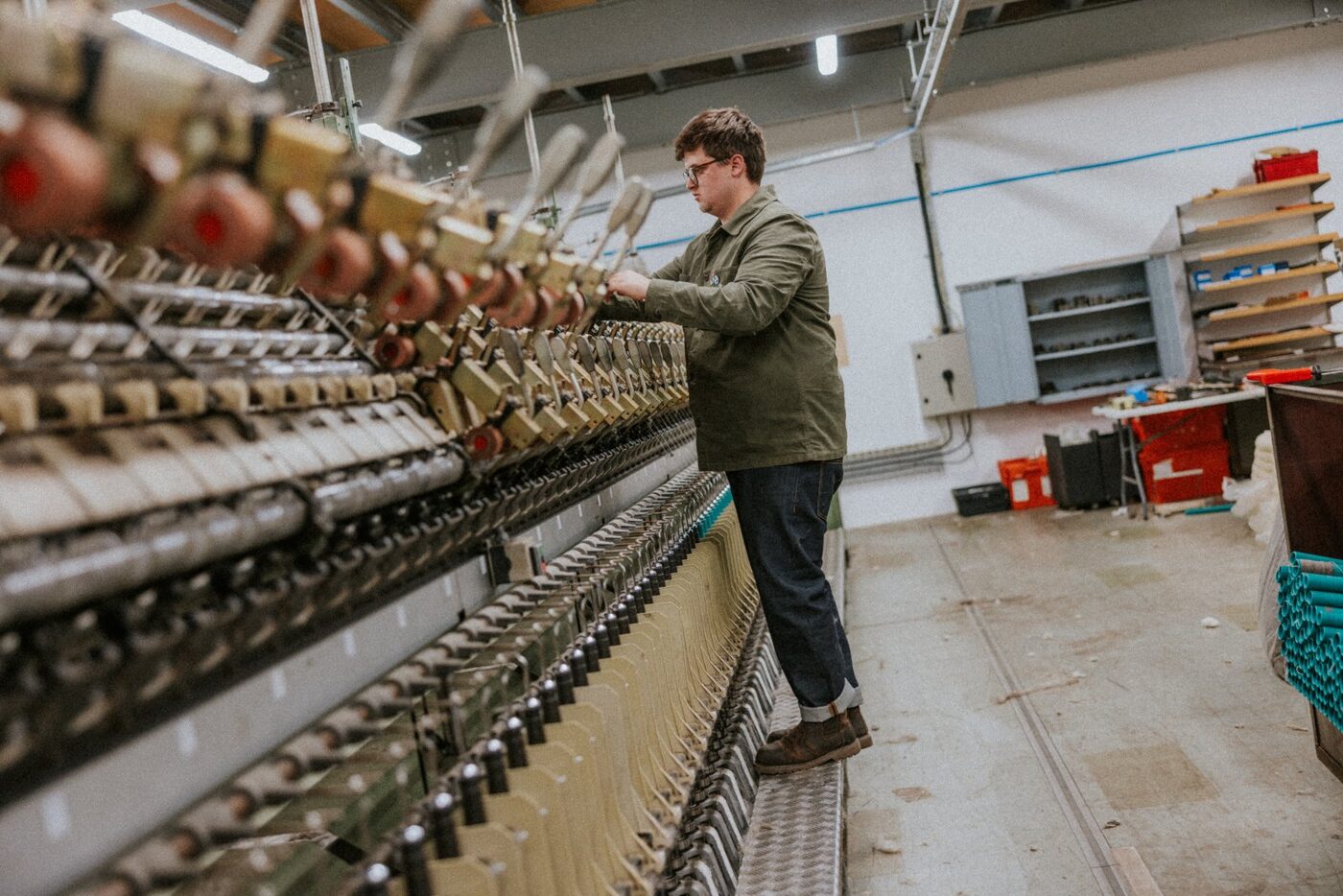 A member of the team working at a spinning frame in the mill